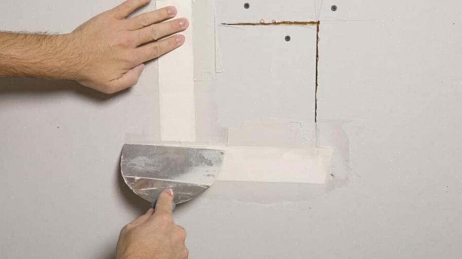 Cubra a fita de drywall com uma camada fina de composto de junta de drywall